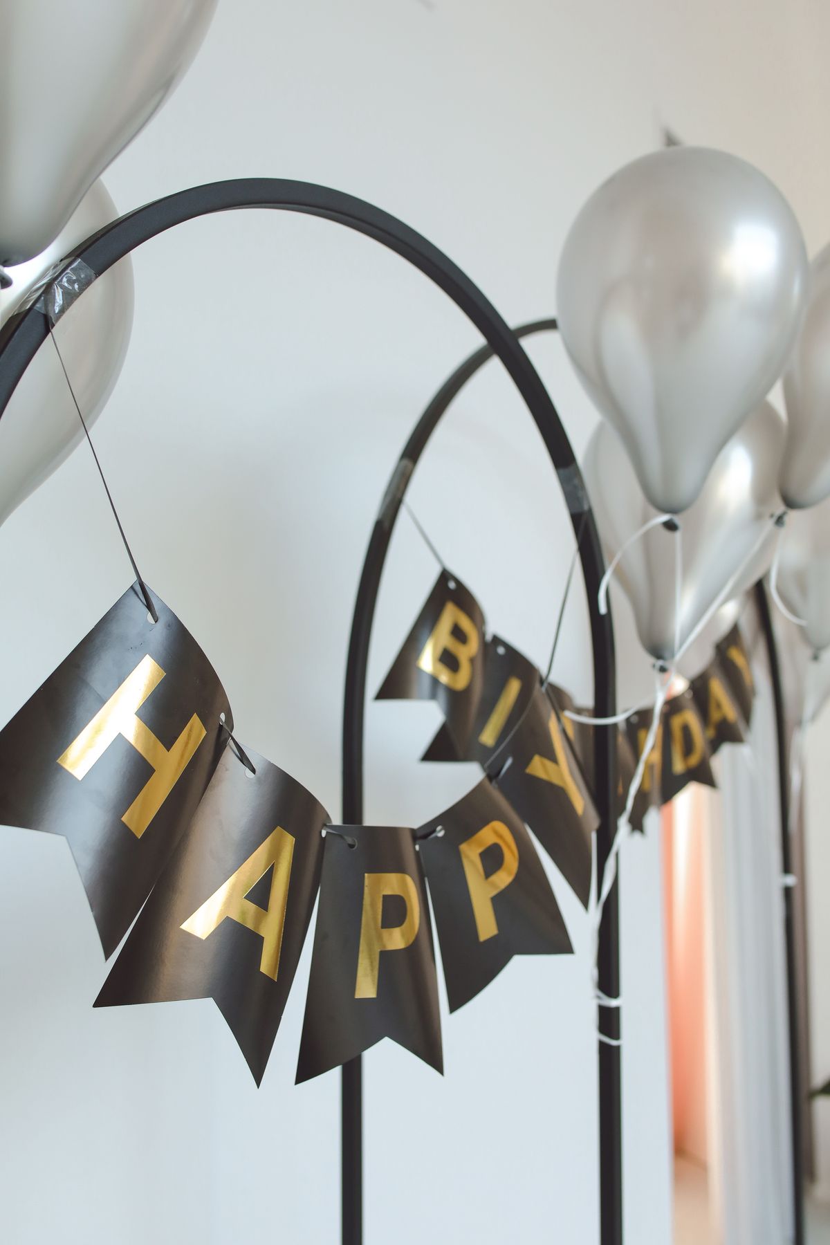 Stylish silver balloons with a 'Happy Birthday' banner creating a modern party atmosphere.