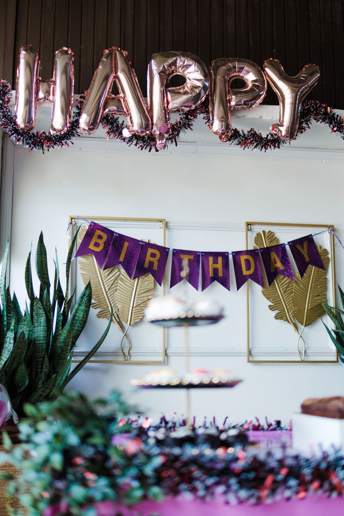 Colorful birthday party setup with balloons and festive banners indoors.